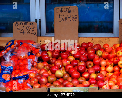 Apples and mandarin oranges on sale outdoors at a shop in New York City's Chinatown. Stock Photo