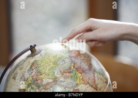 Pointing at globe Stock Photo