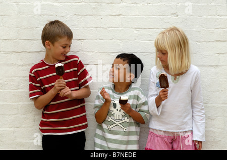 Three children eat ice creams Stock Photo