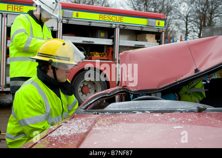 Firemen on training exercise in a simulated car crash Stock Photo