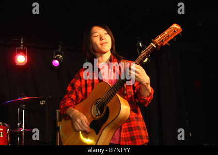 Young man playing the guitar on the stage Stock Photo