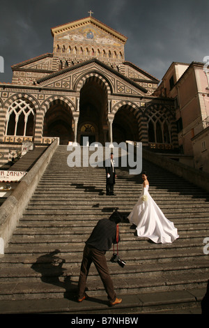 New married couple takes photos on the monumental staircase of the Amalfi Cathedral in Campania, Italy. Stock Photo