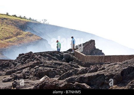 Masaya active shallow shield volcano National Park visitors on overlook of smoking crater Stock Photo