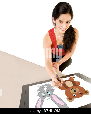 A young woman is drawing on a digital tablet Stock Photo