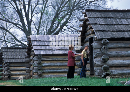 Visitors examine Muhlenberg Brigade huts, Valley Forge National Historical Park, Pennsylvania. Stock Photo