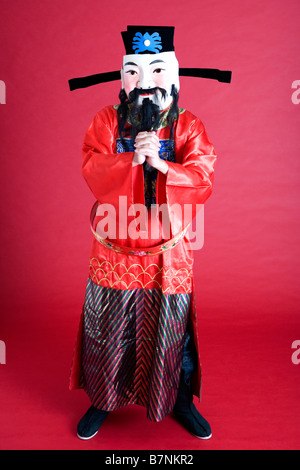 Young man in costume with hands clasped Stock Photo
