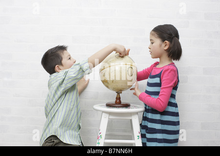 Children and a terrestrial globe Stock Photo