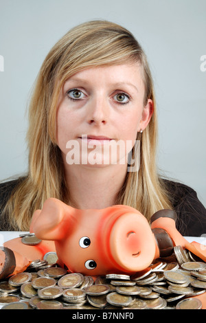 young woman smashed piggy bank Stock Photo - Alamy