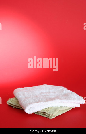 Towels isolated on red background Stock Photo