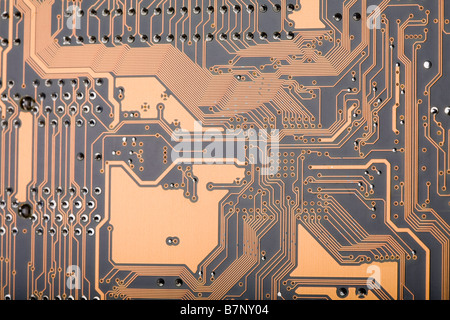 Close up of a section of the back of a computer motherboard circuit board Stock Photo