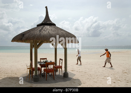 Table set for lunch on the beach at Belle Mare Mauritius Stock Photo