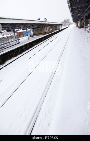 A suburban railway station deserted due to heavy snow fall and frozen points Stock Photo