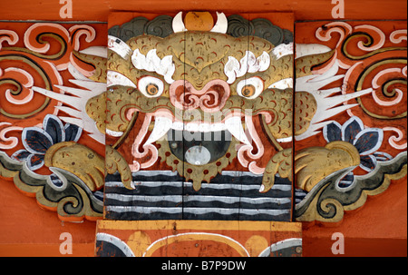 Representation of a dragon painted in traditional Bhutanese style at the top of a concrete column in a new building. Stock Photo
