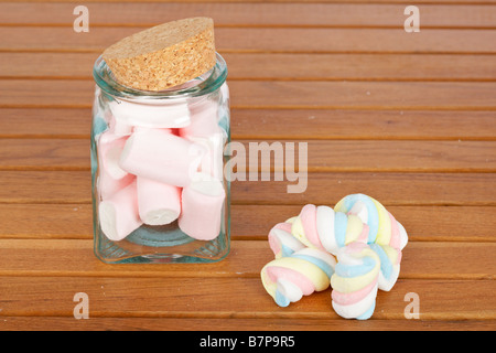 Marshmallows in the glass jar on wooden background Stock Photo