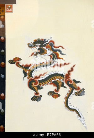 Representation of a dragon painted in traditional Bhutanese style on the wall of a house. Stock Photo