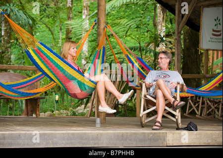 Central America, Costa Rica. A couple relax at a remote lodge on The Pacuare River. Stock Photo