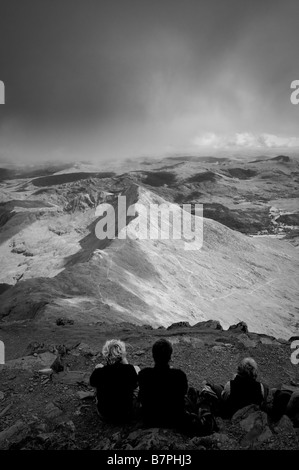 Walkers resting at summit of mount Snowdon Wales Stock Photo