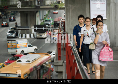 Woman trying to avoid traffic pollution with handkerchief Pathumwan district in central Bangkok Thailand Stock Photo