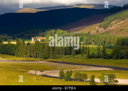 The River Dee meandering past Mar Lodge, near Braemar, with the hills of Ben Macdui and Derry Cairngorm in the Cairngorms behind Stock Photo