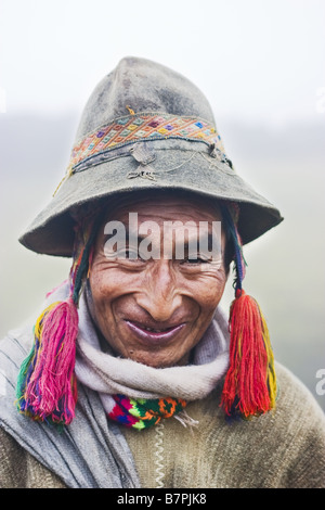 A Q'eros elder stands in the mist wearing traditional alpaca wool clothing and embroidery. Stock Photo