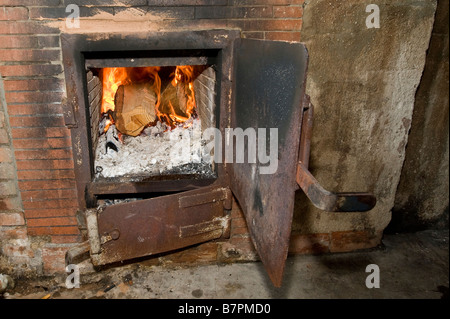 Fire burning in the oven for Souma (Tsipouro) destillation Stock Photo