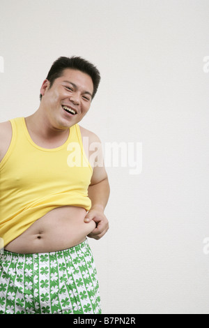 A man pinching his belly Stock Photo