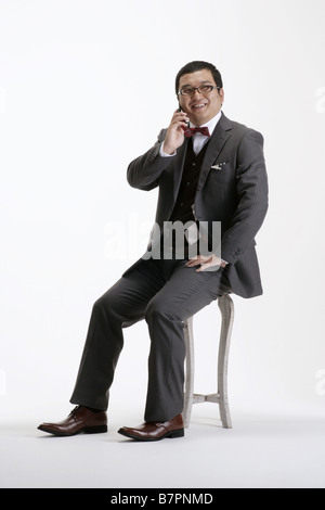 A man in suit making a call on his cellphone Stock Photo