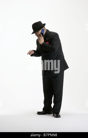 A man in suit making a call on his cellphone Stock Photo