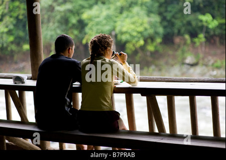 Central America, Costa Rica. A woman and man relax at a lodge on the Pacuare River. Stock Photo