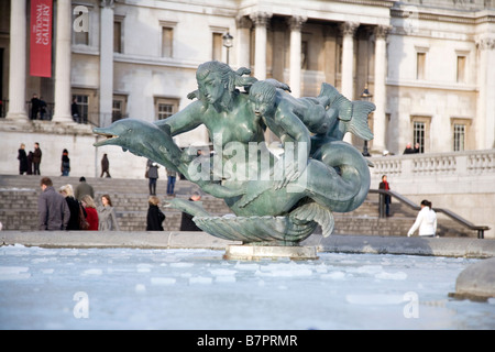 statue in middle of trafalgar square fountain under ice in london Stock Photo