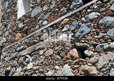 Coloured wall stones background of old abandoned building in mountain village Kakopetria, Trodos mountains, South Cypru Stock Photo