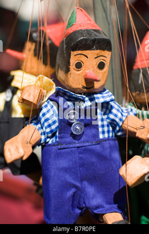 Wooden, painted Pinocchio puppets on display in a shop in Brussels, Belgium Stock Photo