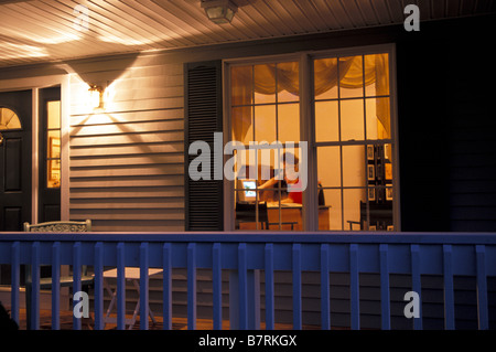 Home Office at dusk through window Stock Photo