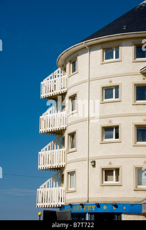 Modern creamy white rendered seafront apartments with curving walls and and a conical roof. Aberystwyth Wales Stock Photo