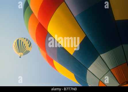 Colorful hot air balloons fill the sky as they float above the unique ...