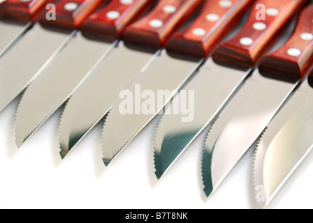 Steak knives in a row on white background Stock Photo