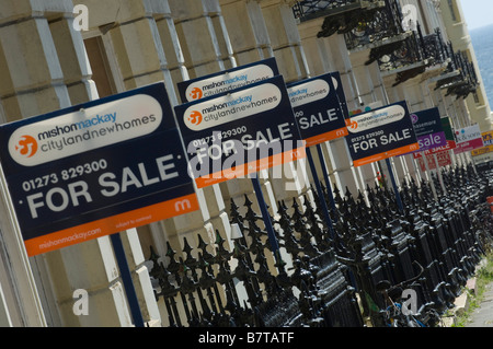 An abundance of For Sale sign boards on railings of period houses on Holland Road Hove in the City of Brighton Hove East Sussex Stock Photo