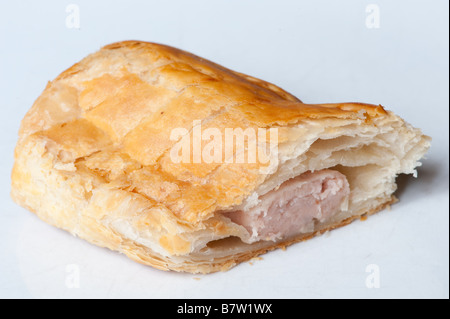 a sausage roll cut in half on a white background Stock Photo