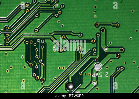 Extreme close up view of reverse connection side of circuit board showing holes and silver conducting strips. Stock Photo