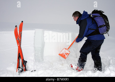 Skier Digging a Snowpit in Order to Assess Avalanche Danger United Kingdom Stock Photo