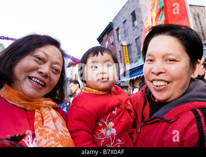 Two elderly Chinese women holding a child Stock Photo