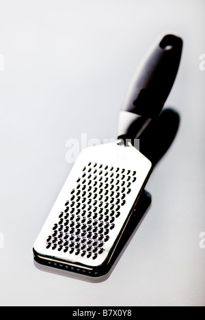 A metal grater with black handle isolated on white with shadow Stock Photo