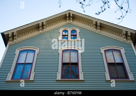CHICAGO Illinois Second floor and attic windows moulding details on home with wooden siding Old Town triangle neighborhood Stock Photo