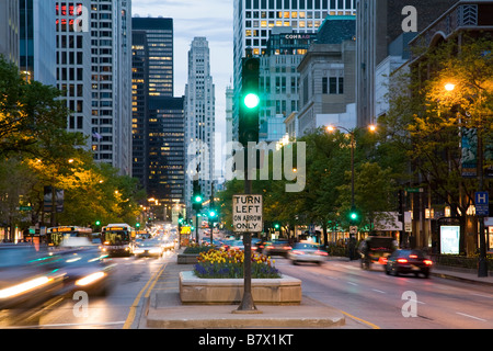 ILLINOIS Chicago Traffic signal in median of Michigan Avenue at dusk blur of cars passing left turn on arrow sign Stock Photo