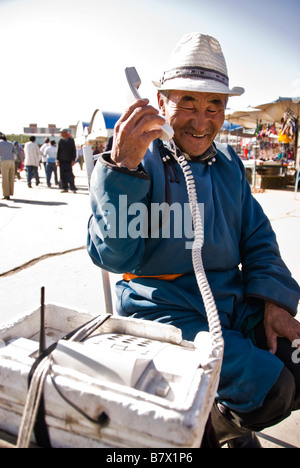 Old Mongolian man dressed in a traditional way making a phone call Ulan Bator Mongolia Stock Photo