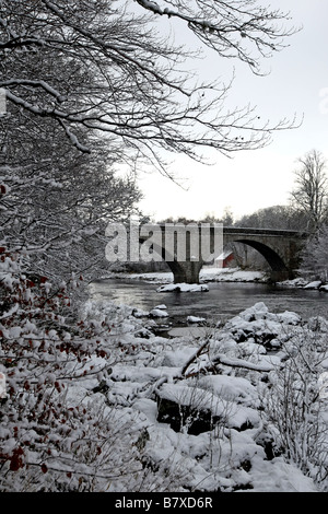 Potarch Bridge over the River Dee near Banchory in Aberdeenshire, Scotland, UK, seen covered in snow during winter Stock Photo