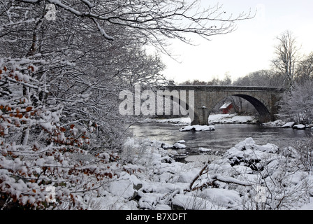 Potarch Bridge over the River Dee near Banchory in Aberdeenshire, Scotland, UK, seen covered in snow during winter Stock Photo