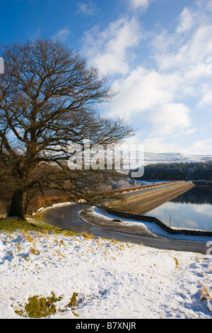 Winter view of Road across Errwood Dam on Errwood Reservoir in the Goyt Valley in the Peak District in Derbyshire Stock Photo