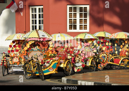 Colourful rickshaws lined up in the street in Melaka, Malaysia Stock Photo
