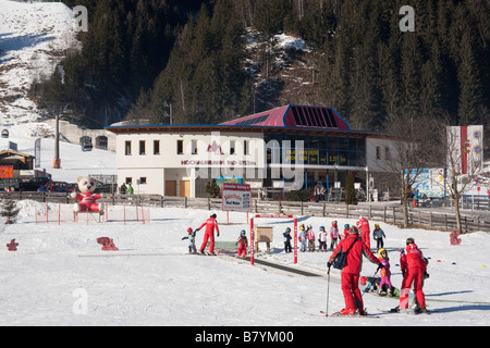 Children learning on ski school nursery slopes in Alpine resort in Austrian Alps in winter snow. Rauris Austria Europe Stock Photo